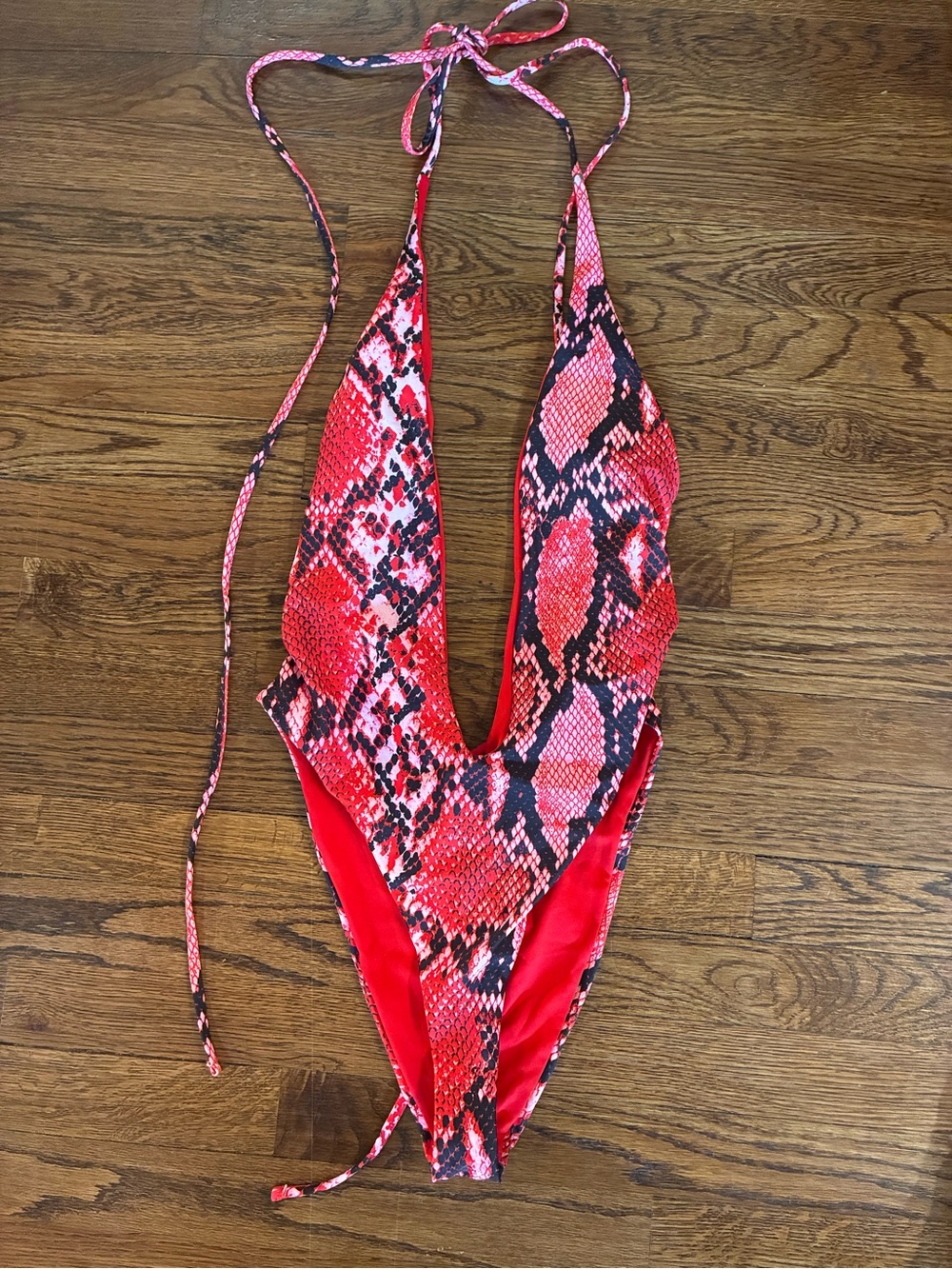 New with no tags. Never worn. Red Snake-Print One-Piece Bodysuit